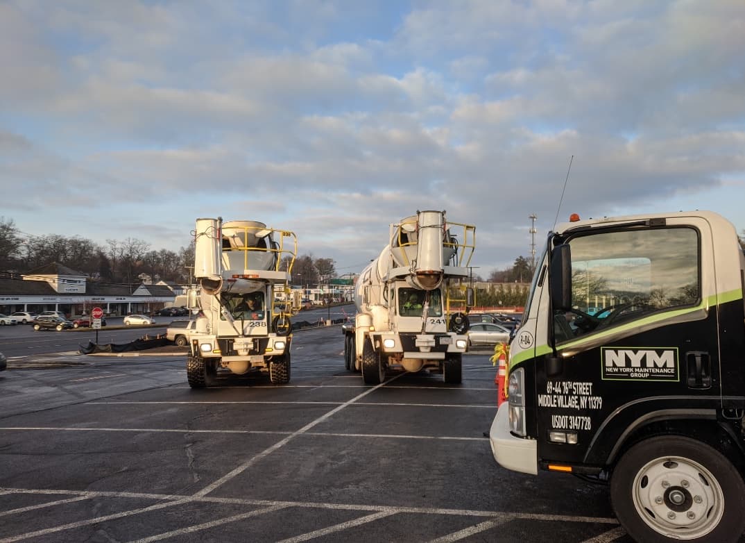NYM Group concrete mixer trucks staged on a commercial job site